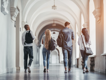 Group of people walking down a hallway